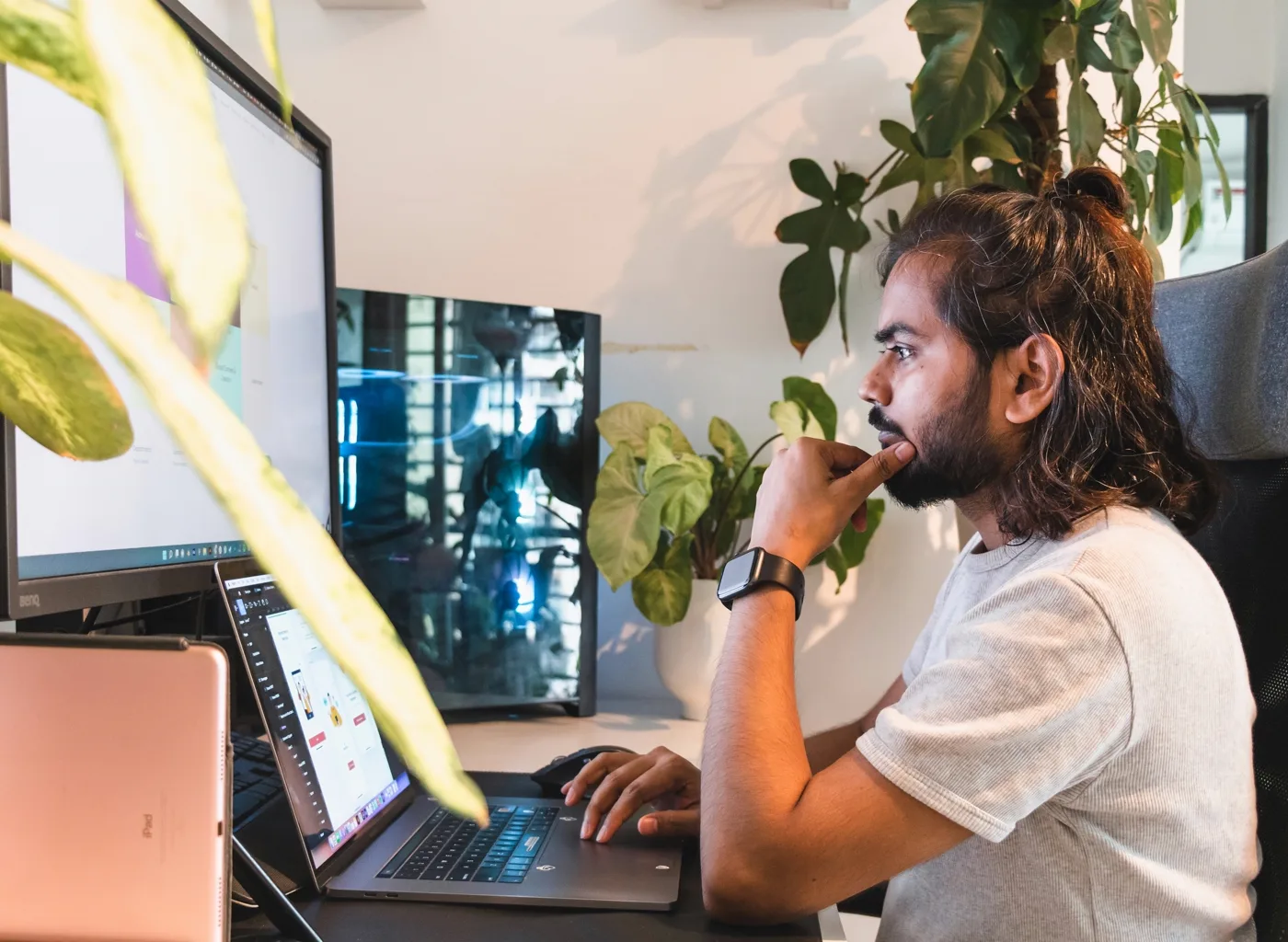 Developer working confidently on a laptop in a bright modern office