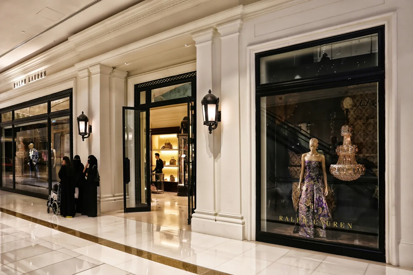 Luxurious storefront interior with grand staircase and geometric ceiling