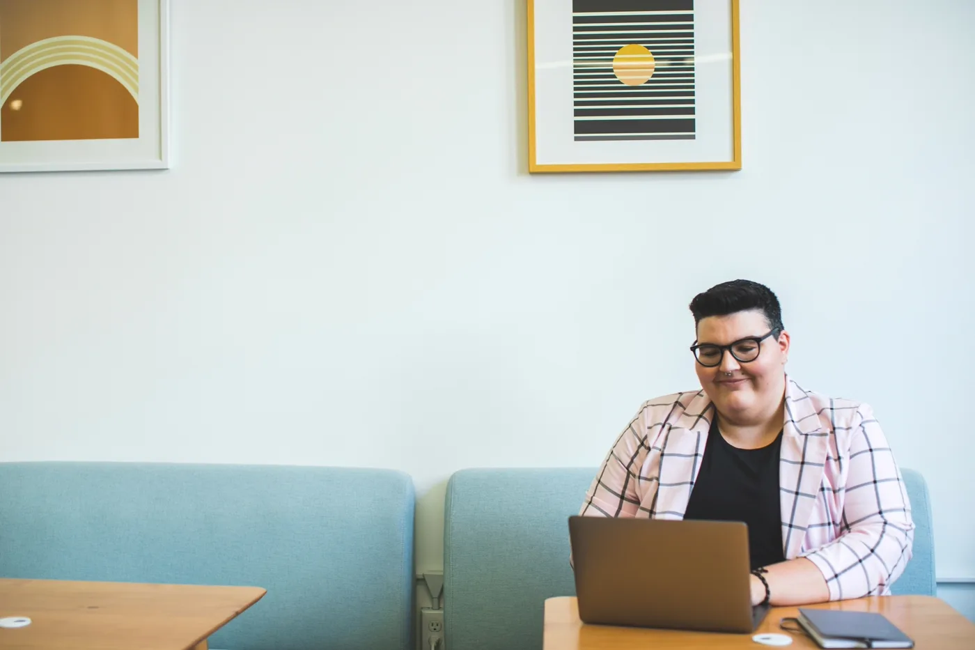 Confident developer building a custom Shopify app on a laptop in a bright studio