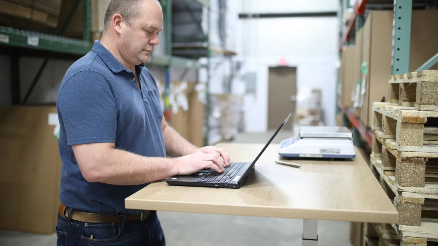 Ops manager reviewing an automated order fulfillment dashboard in a bright office