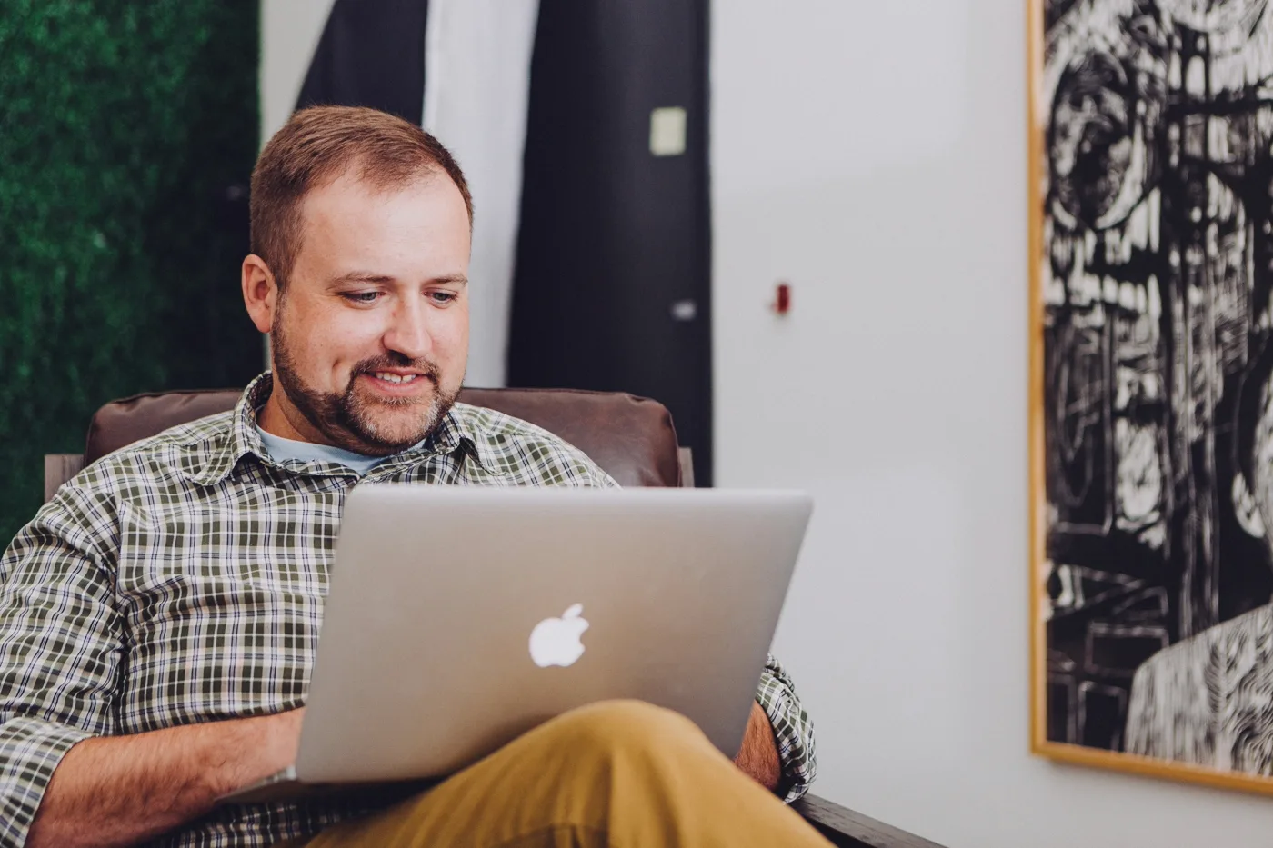 Founder smiling while reviewing the finished storefront launch on a laptop