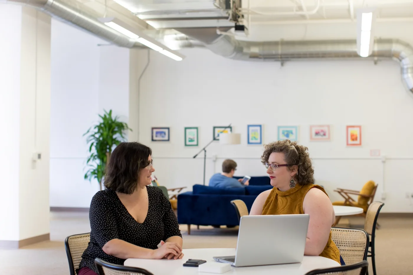 Team discussing ongoing Shopify maintenance and support plans around a table
