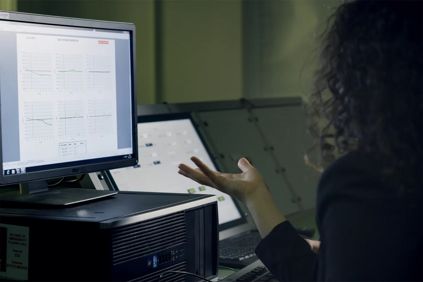 Support engineer calmly reviewing uptime and performance dashboards