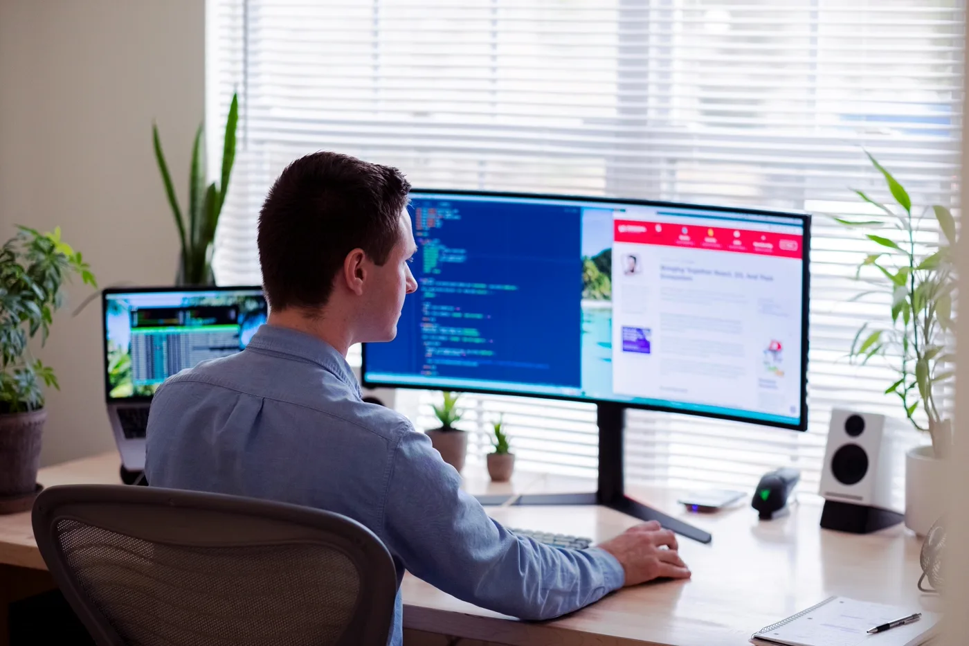 Developer in dress shirt reviewing a theme update on a monitor