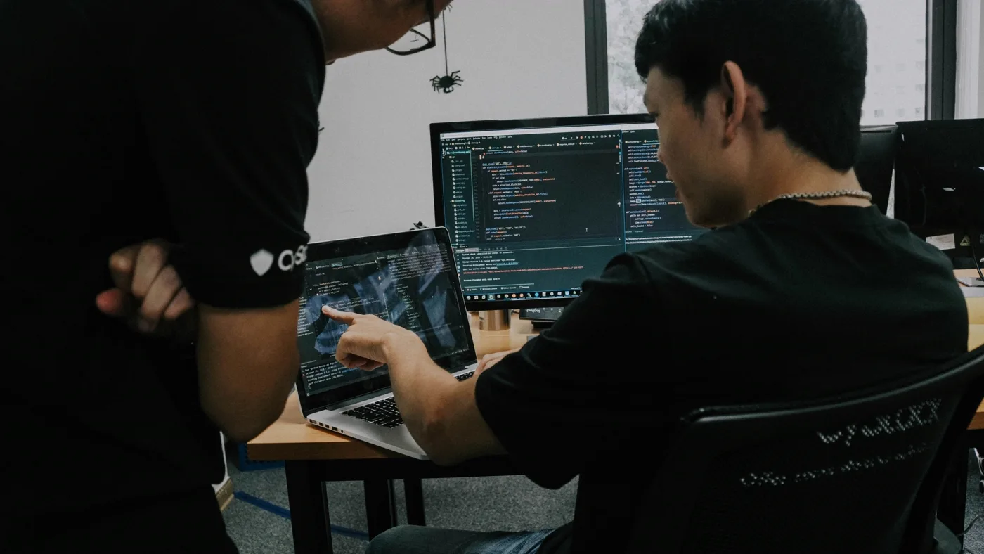 Two engineers reviewing a performance audit together in a bright office